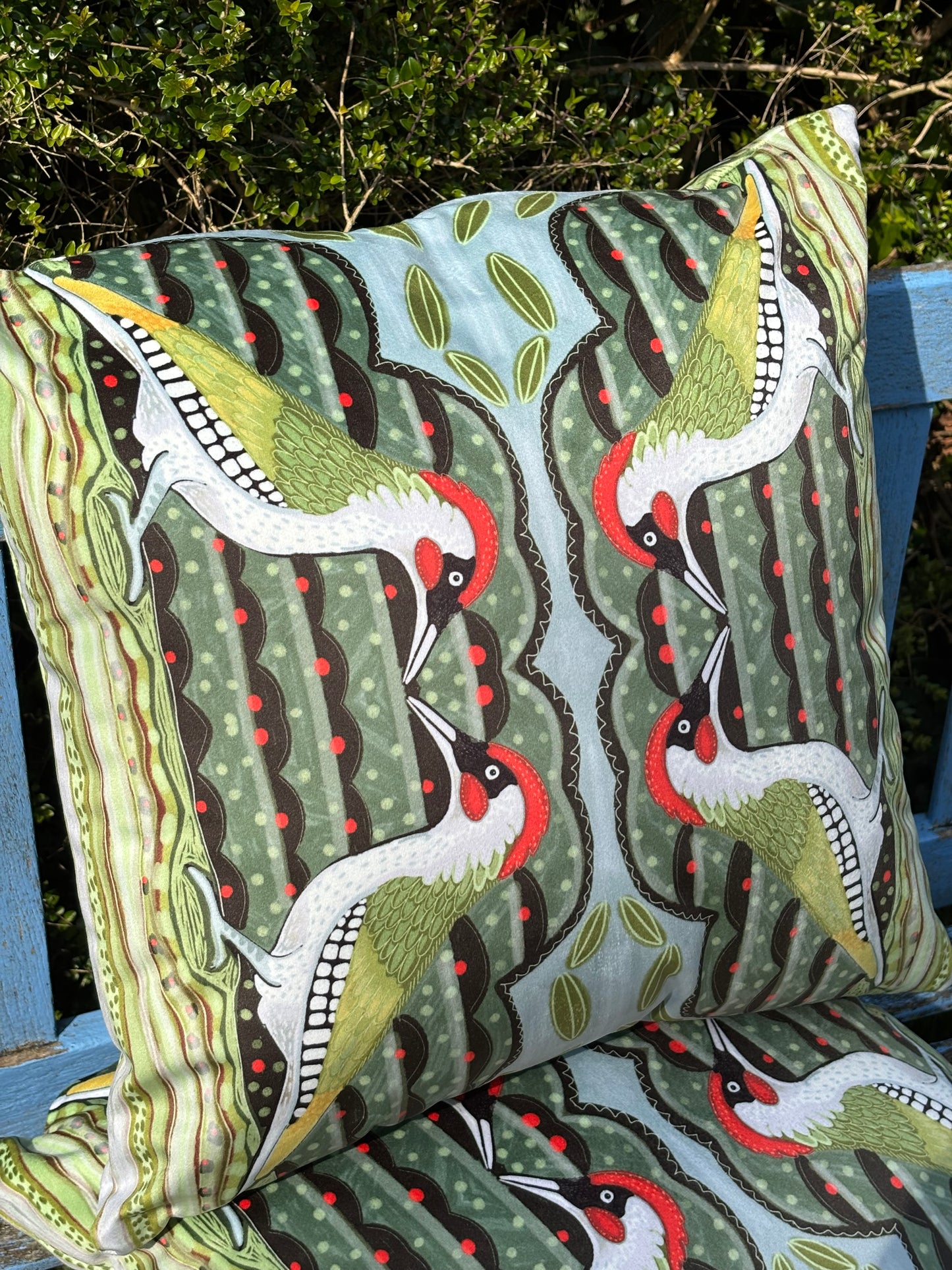 Green woodpecker faux suede cushion.